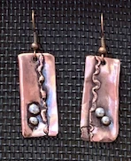 Click to read about Ernie’s signature jewelry collection