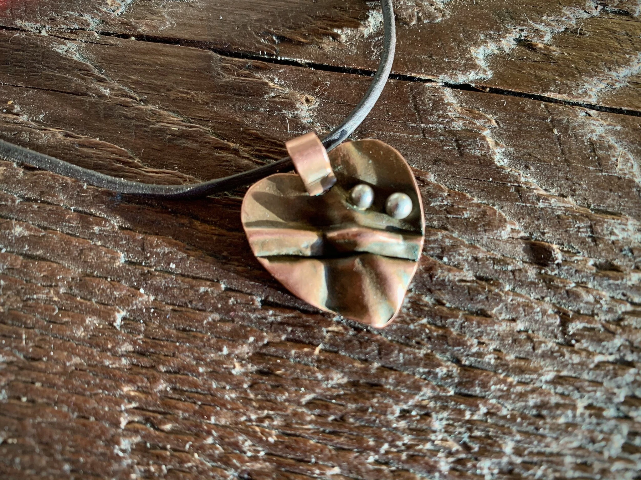 Local artist, Ernie Lopez created this Heart Necklace that inspired there template for the International Peace Heroes Trail experience we've been creating at Casa de Peacebuilder. The two silver bumps on the copper represent the lives of Oscar Alber…