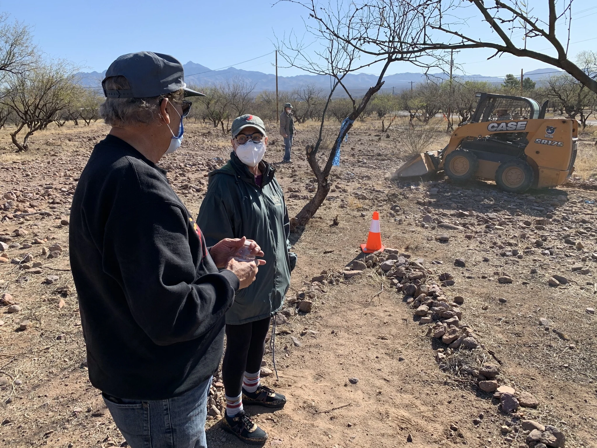 Dr. Jose Lopez, Co-Trail leader, and Patsy Ferrell, watch on as trail construction moves forward in March, 2021.